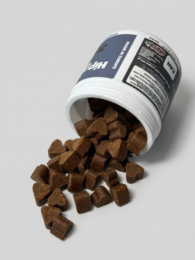 White container with brown pet treats spilling out on a gray background