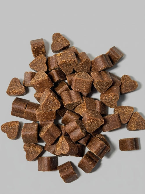 Brown dog treats on a gray background