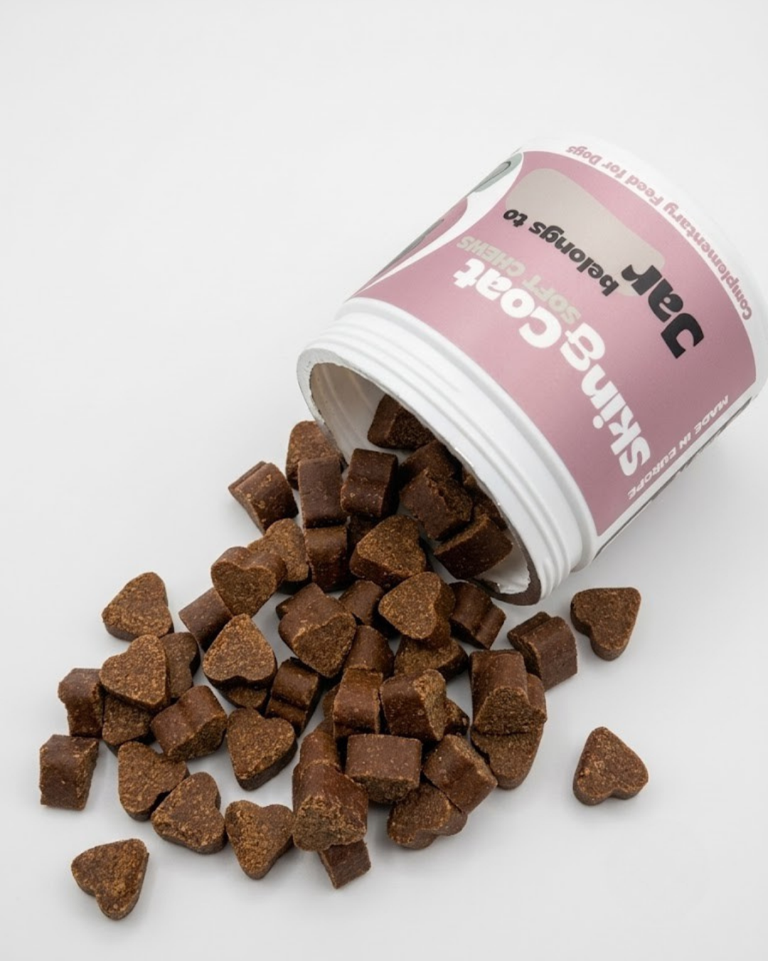Pet treats spilling out of a tipped-over container labeled 'Jefr' on a white background