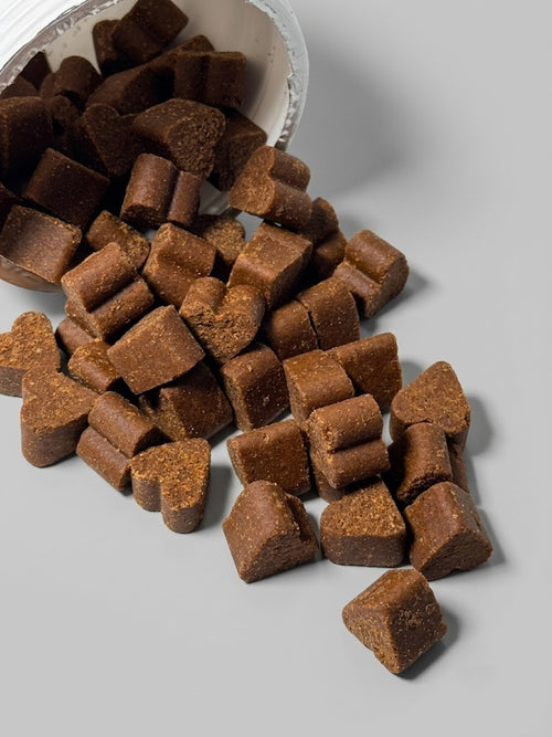 Brown pet treats on a gray surface